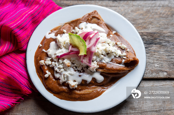 Mexican tacos with beans sauce and fresh cheese also called  Enfrijoladas