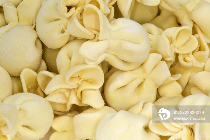 Uncooked frozen meat dumplings original shape, fragment close-up