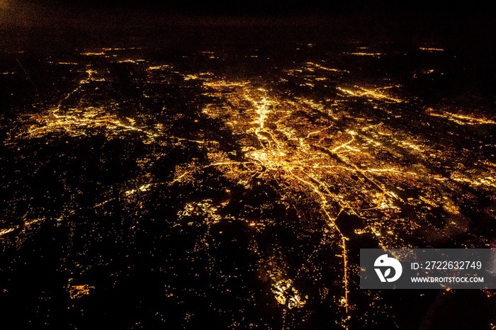 Flying at night over cities below