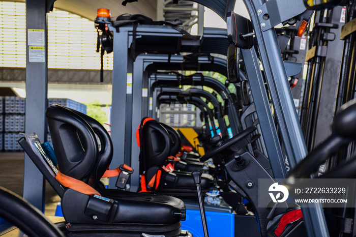 Forklift trucks parked in a warehouse.