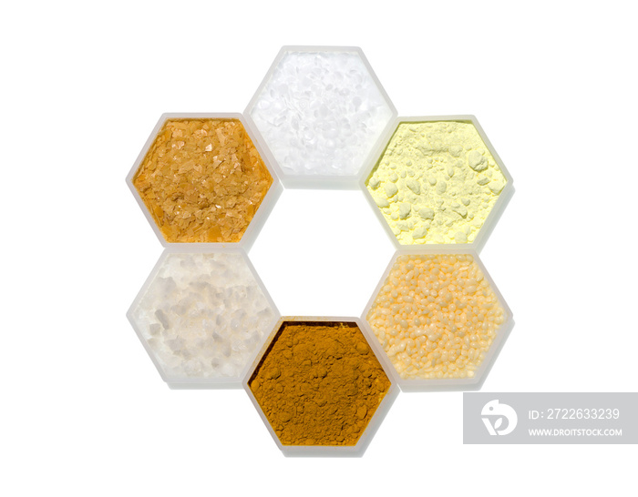 Chemical ingredient in hexagonal molecular shaped container. Microcrystalline Wax, Sulfur Powder, Candelilla Wax, Curcuma Powder, Flake Salt and Carnauba Wax