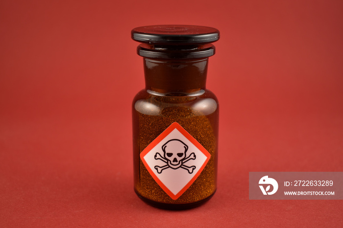 Vial with poison stock images. Vial with warning pictogram stock images. Laboratory accessories. Vials on a red background. Brown glass containers. Brown chemical glass