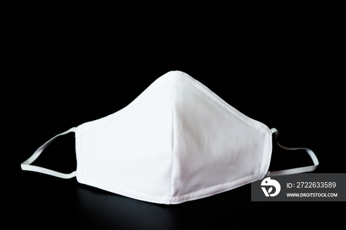 Cloth white mask isolated on black background - for prevent dust (PM 2.5), .disease (Coronavirus or COVID-19).