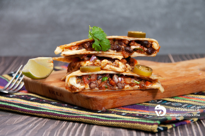 Beef Quesadillas isolated on wooden board and mat side view of fastfood on wooden background