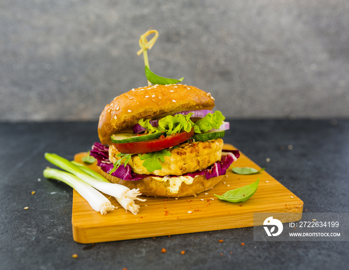 Vegetarian burger with grilled tofu with herbs and raw vegetables. Healthy diet.