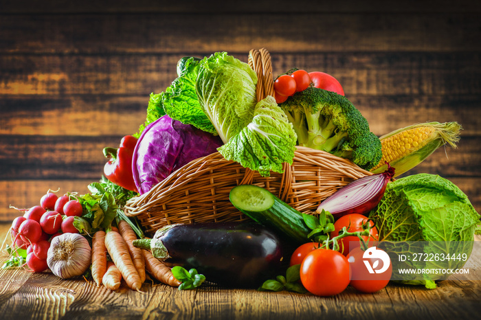 Assortment of raw fresh vegetables, mixed vegetable in wicker basket.