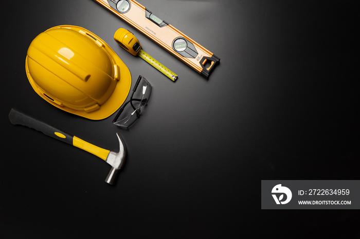 Work safety. Construction site protective equipment on wooden background, flat lay, copy space, top view