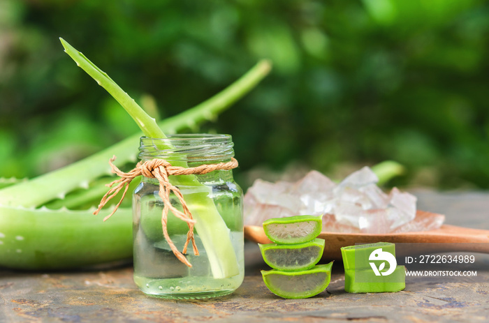 sliced and leaf of fresh aloe vera with  essential oil in glass and gel product on spoon