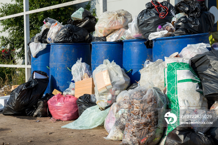 Dumpsters being full with garbage.  Overflowing garbage bins with household waste. overflowing blue garbage bin.