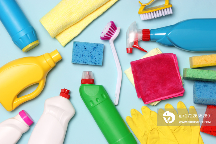 cleaning products on a colored background top view.