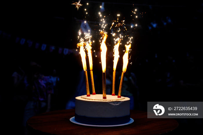 The cake with fireworks on a dark background.