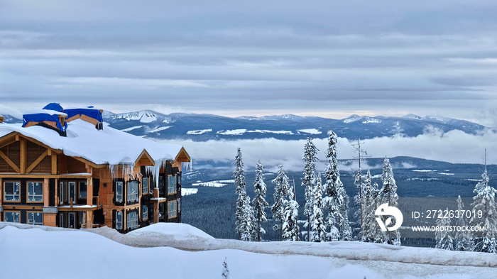 Ski Resort in winter day. Building and snow mountains covered with snow and icicles. Frosty trees. Kelowna. British Columbia. Canada.