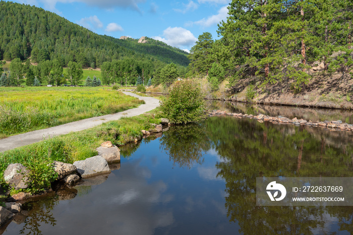 Evergreen Colorado landscape of water, plants, reflections and mountains