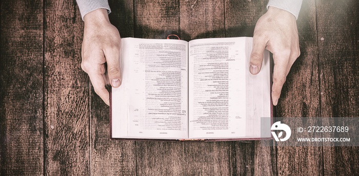 Cropped image man holding bible