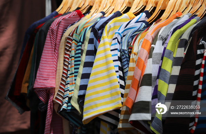 Closeup of colorful cotton cloths hanging on clothing rack  for selling in local market