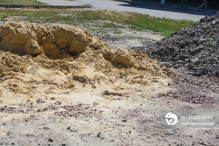 Big mountain of yellow sand at construction site close up