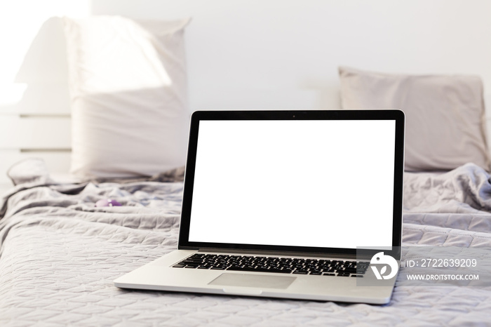 The laptop and computer in the morning on a white pillow bed. Lifestyle Concept