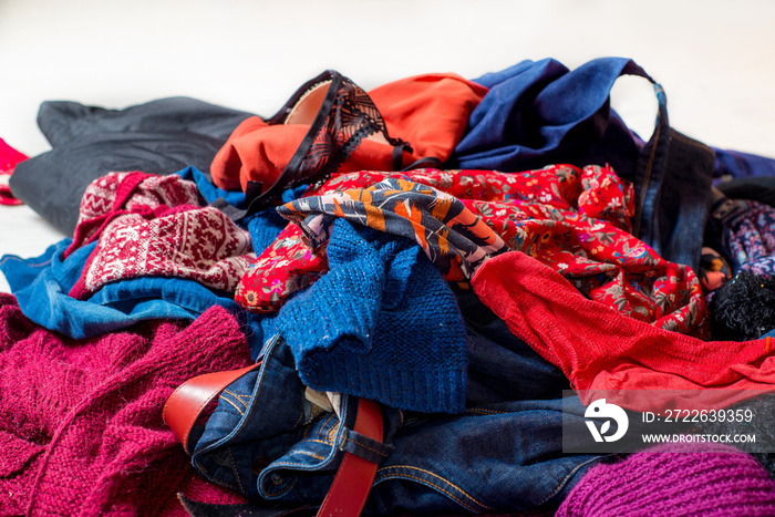 Landfil of used clothes. Pile of scattered second-hand clothes on a white background