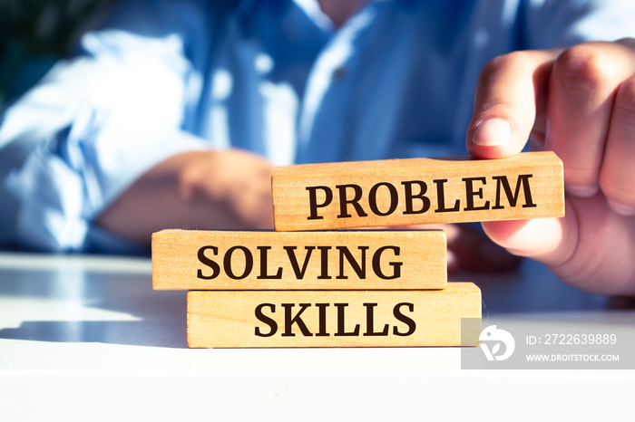 Closeup on businessman holding a wooden block with  Problem Solving Skills  message, Business concept