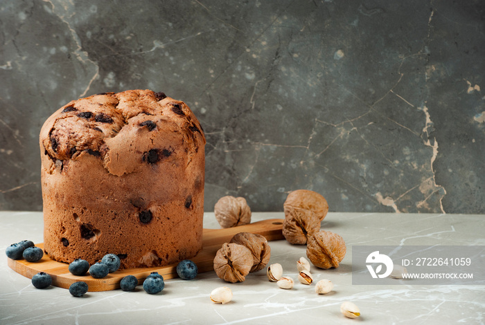 Christmas chocolate cake panettone on marble background, soft light, front view, also know as chocotone panetone