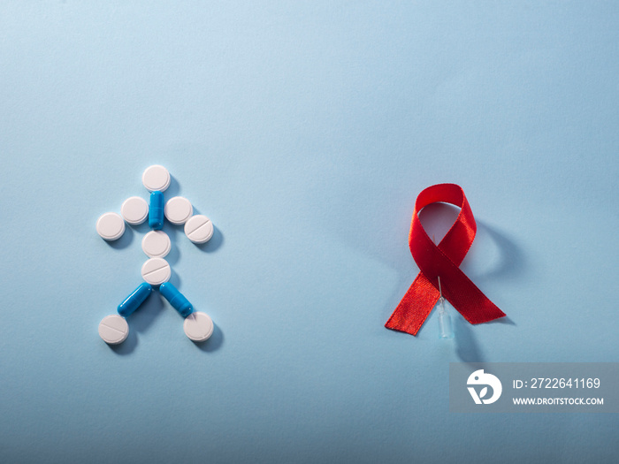 antiretroviral therapy for AIDS. HIV treatment. Red ribbon and pills in the form of a little man on a blue background