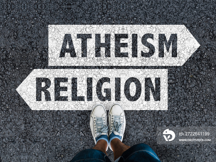 men with a shoes are standing on asphalt next to arrow signs of words atheism and religion