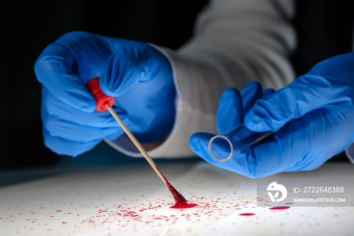 Forensic technician taking DNA sample from blood stain