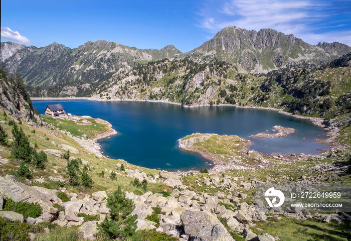 panoramic view of the lake of Colomers and the high mountain refuge of Colomers, in the natural park of aiguastortes in the aran valley, lerida, spain