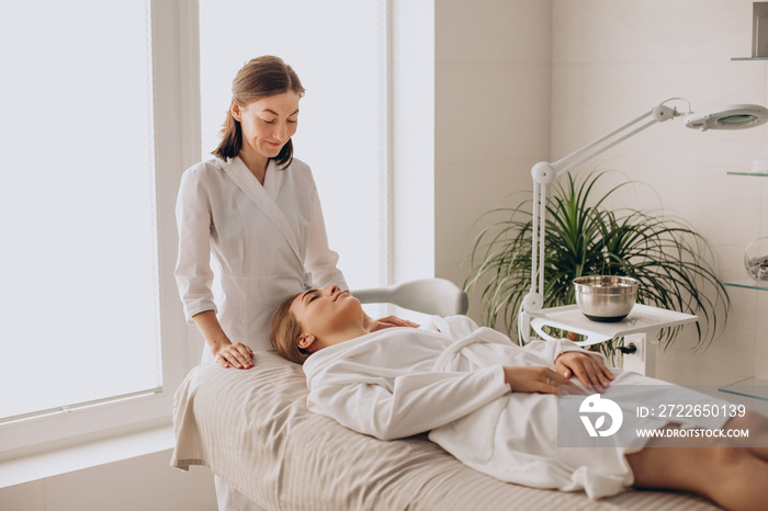 Woman in a beauty salon having face and neck massage