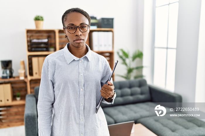 African woman working at psychology clinic skeptic and nervous, frowning upset because of problem. negative person.