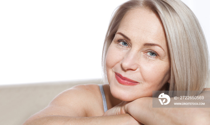 Portrait of cheerful senior woman smiling while looking away at spa. Happy mature woman after spa massage and anti-aging treatment on face. Realistic images with their own imperfections.