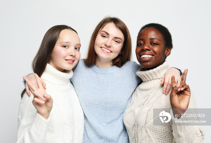 Cheerful European, Asian and African womens.