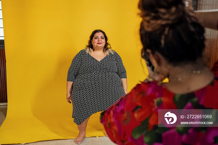 Plus sized female getting her headshots taken by a south asian female photographer