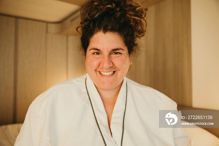 close up of a woman smiling wearing a robe in hotel