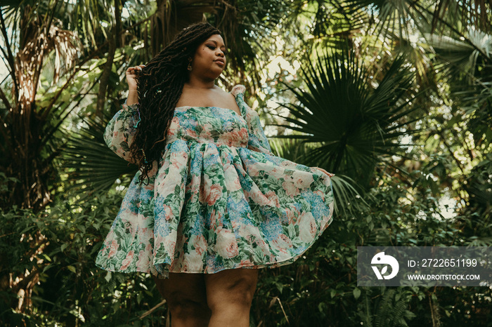 plus size woman holds dress outside