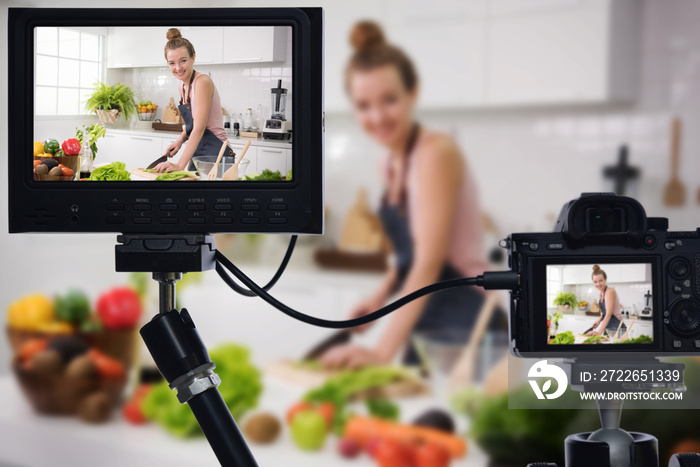 Young female blogger vlogger and online influencer recording video content on healthy food