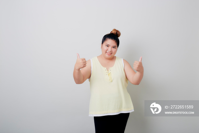 Young Asian woman giving thumbs up