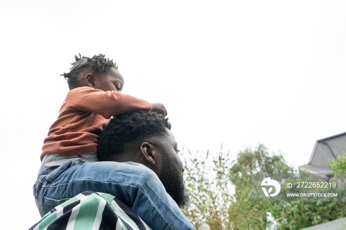 Father giving daughter (2-3) piggyback ride