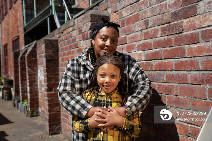 Portrait of mother embracing daughter (6-7)