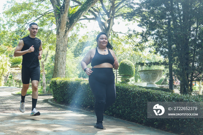 Two friends going on a run together in the park