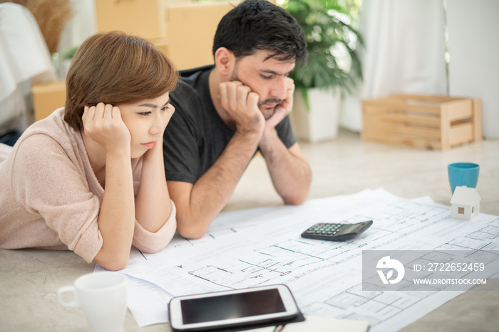 Stressed Young couple calculating their budget.