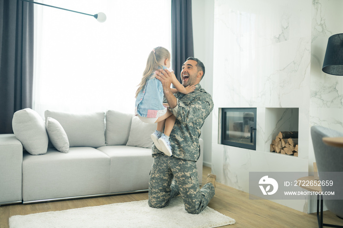 Girl running to her father seeing him in the living room