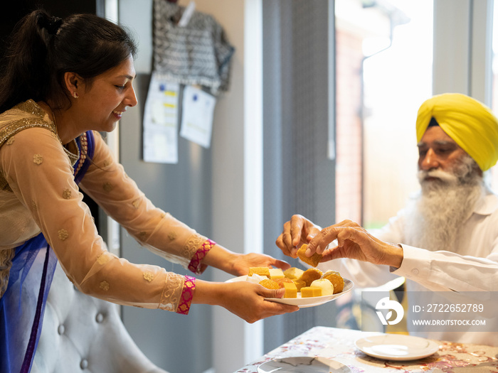 Family in traditional clothing sharing food