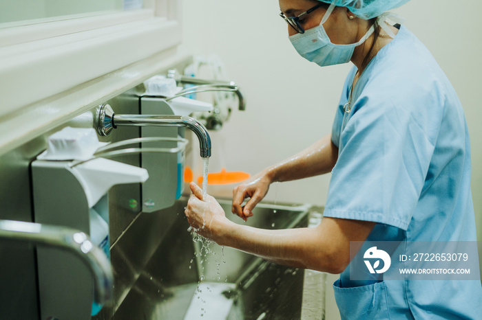 Unrecognizable doctor washing hands before operating