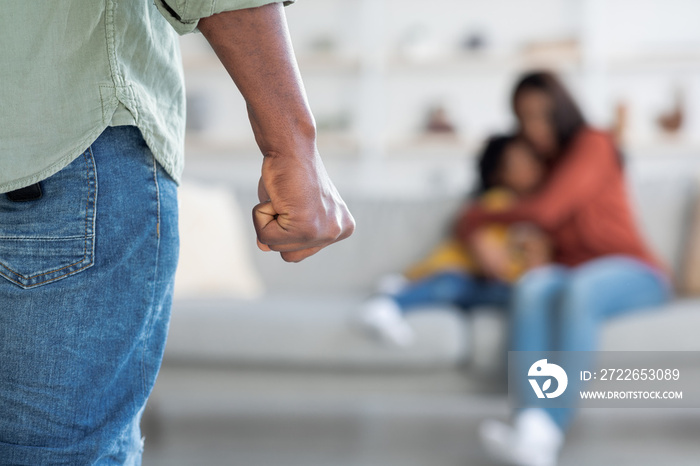 Domestic Violence. African American Man Threatening Wife And Daughter With His Fist