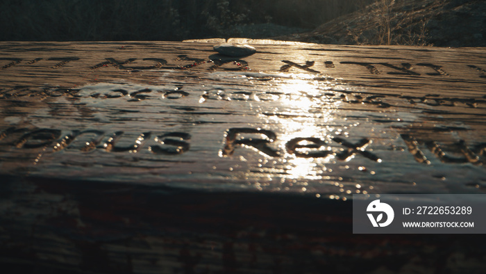 Wooden signboard on cross covered with blood