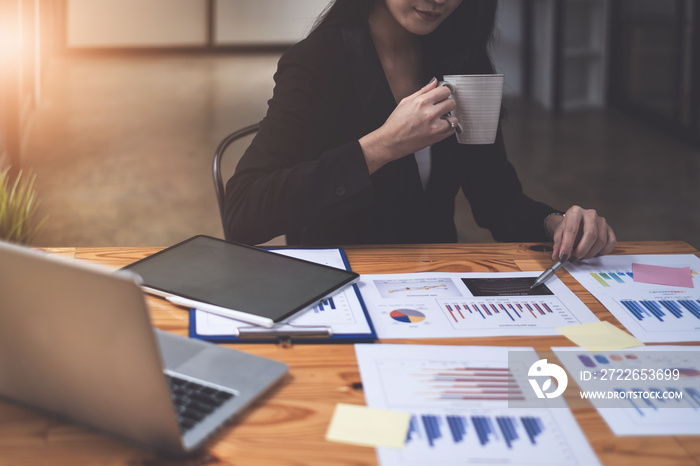 Close-up of a businesswoman using a calculator to audit the company’s budget. Tax information is calculated by accountants.