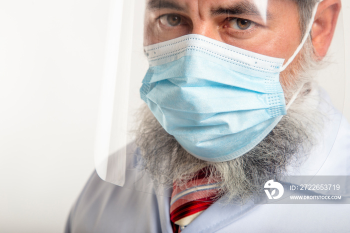 Doctor in protective wear, mask and face shield