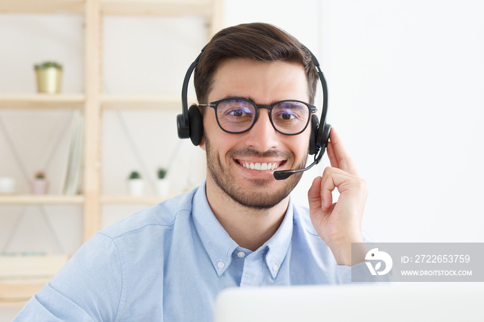 Customer service. Close-up portrait of young male technical support in call centre