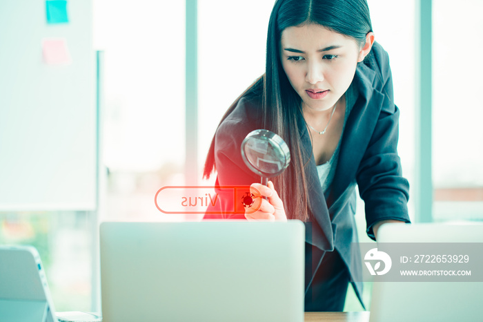 Business women searching through computer data looking for malware, virus, or other embedded data.